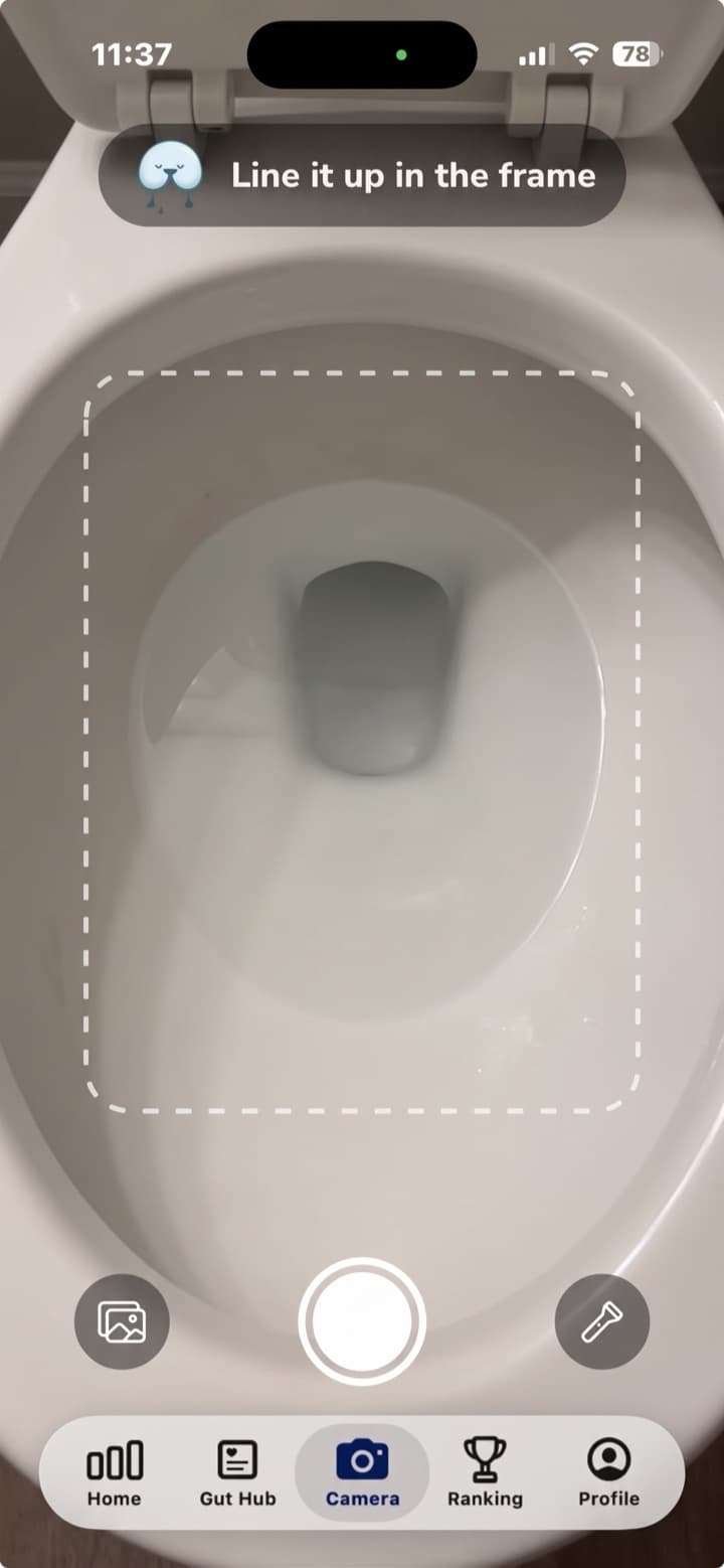 The camera screen with a dashed frame over the toilet bowl and the prompt "Line it up in the frame"